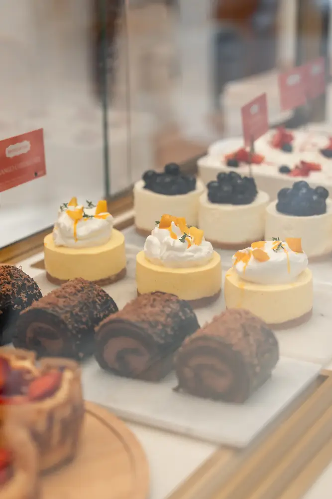 Cheesecakes, berry tarts and chocolate rolls in the Brunch & Cake glass counter